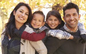 A family enjoying healthy smiles thanks to expert-treated gum disease.