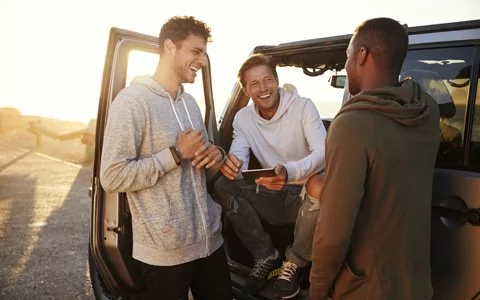 A trio of young men with healthy teeth and gums.