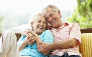 Smiling husband and wife received dentures and implant dentures in Chattanooga