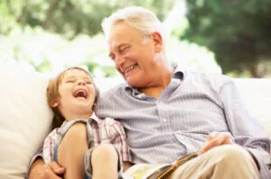 A grandfather reading with his grandson, unconcerned about sleep apnea in Chattanooga.